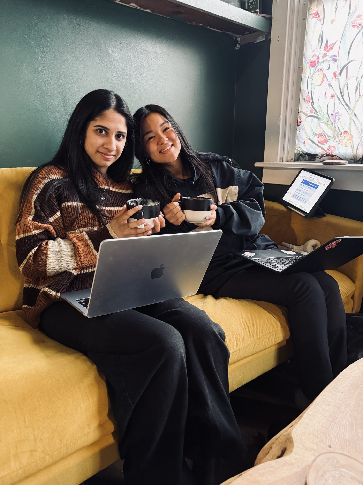 Friends enjoying coffee on the mustard sofa